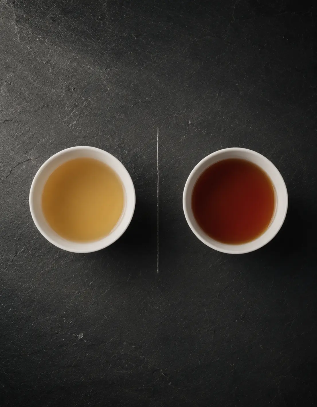 Two cups of tea seen from above showing different liquor colors for comparison
